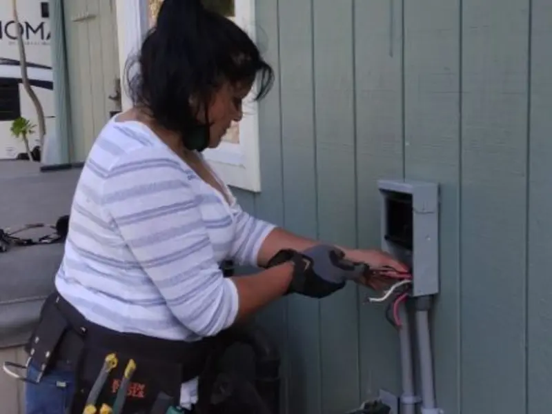 Licensed electrician wiring an exterior subpanel in Garner